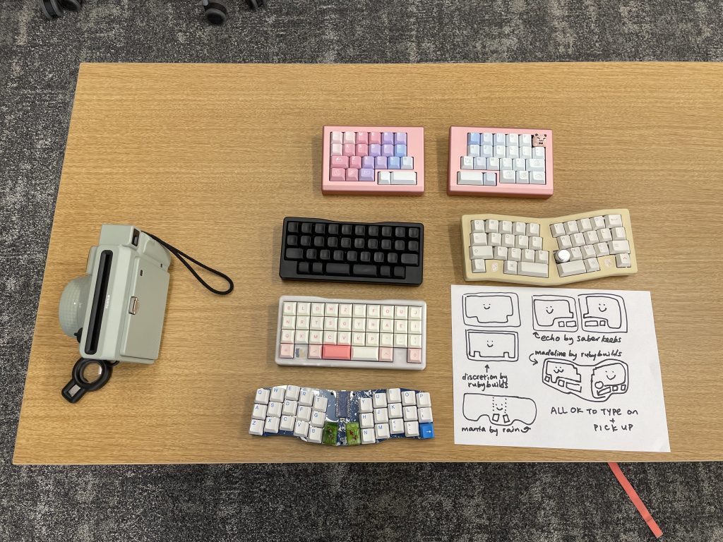 An attendee's large collection of smol keyboards.