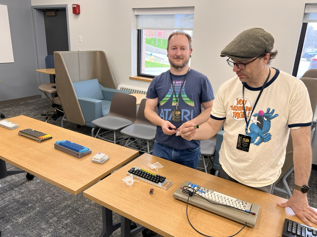 Kim standing in front of his collection of boards. Trevor examines the Slimer artisan's thicc proportions.